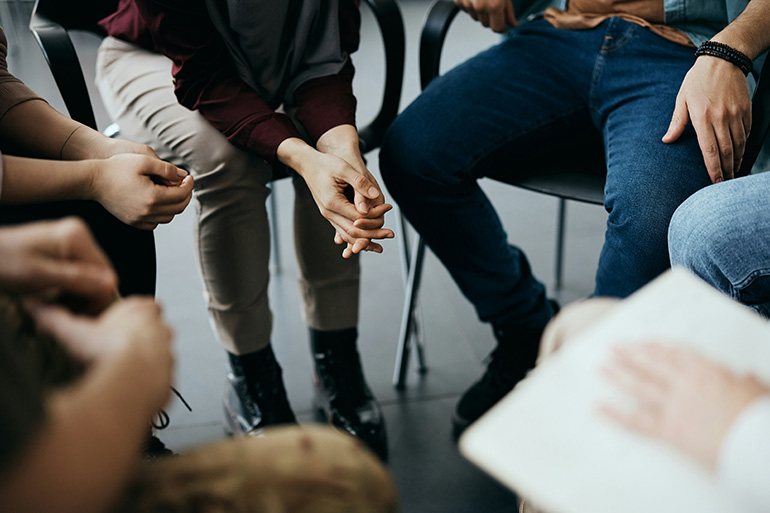 People participate in group therapy at a drug rehab.