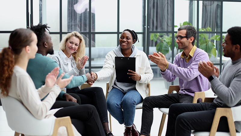 People participate in group therapy at a drug rehab.