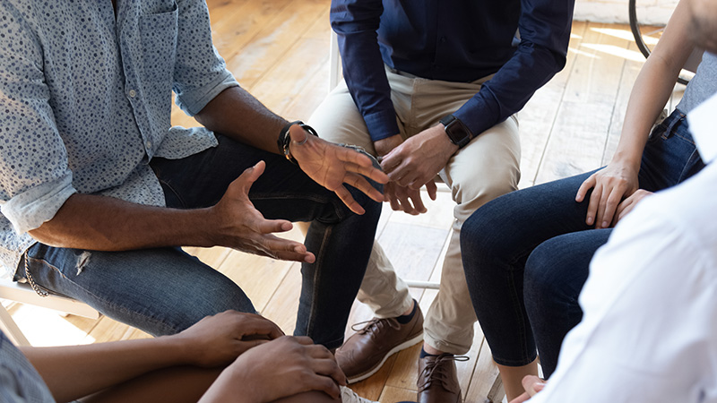 People participate in group therapy at a drug rehab.