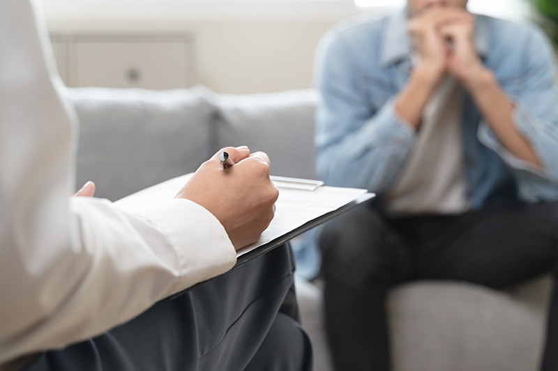 A person participates in therapy at a drug rehab center.