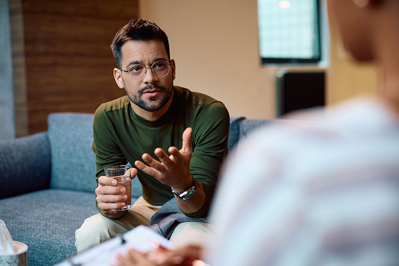 A man participates in therapy as part of a bipolar disorder treatment program.