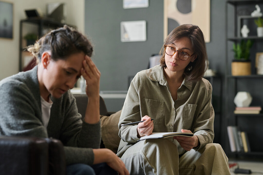 A woman talks to a provider during alcohol detox.