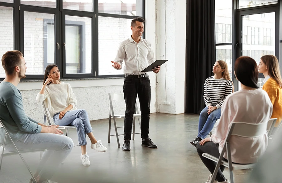 People participate in therapy at a drug rehab center.