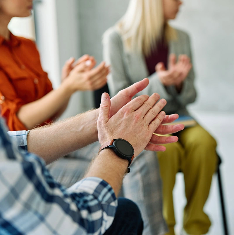 People participate in therapy at a drug rehab center.