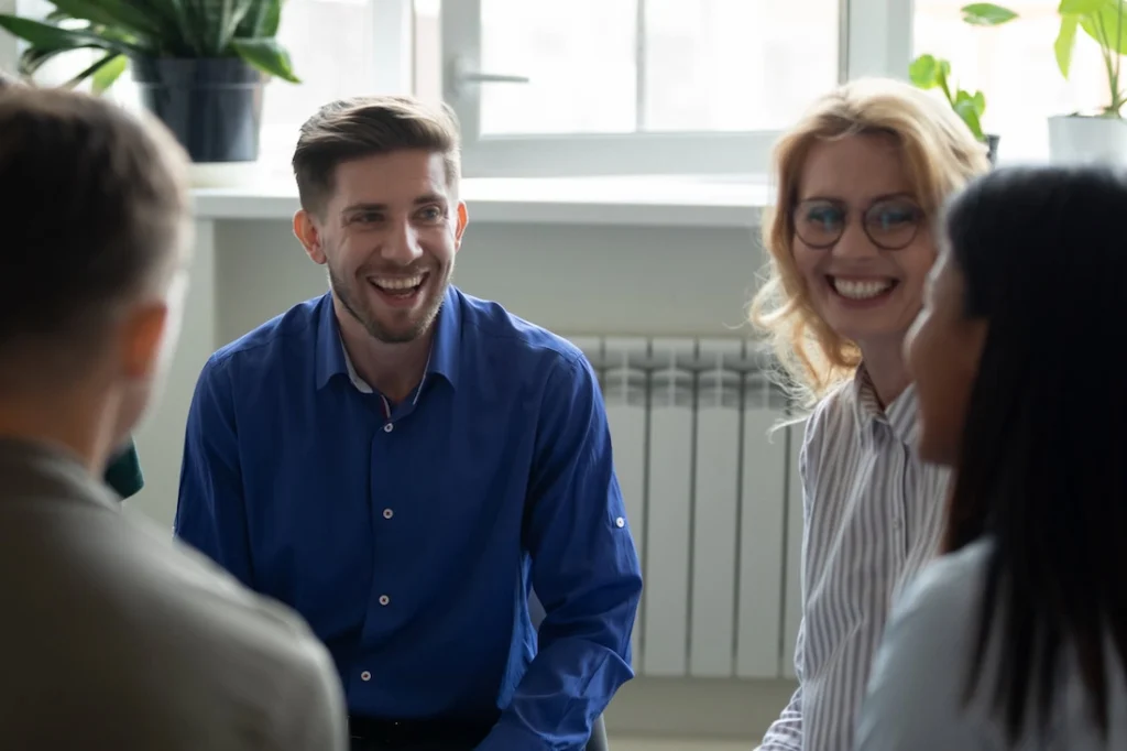People participate in group therapy at a drug rehab center.