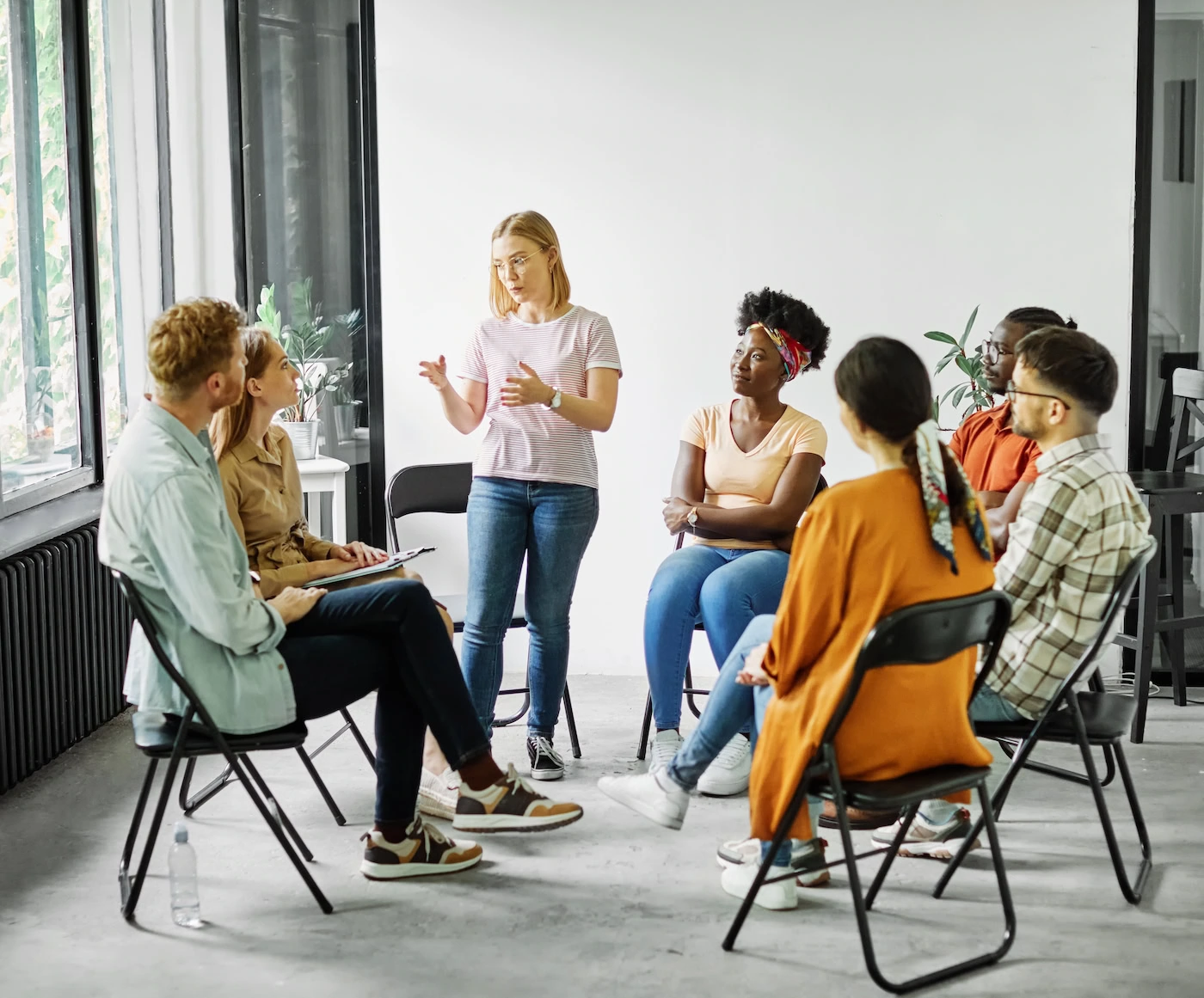 People participate in group therapy at a drug rehab center.