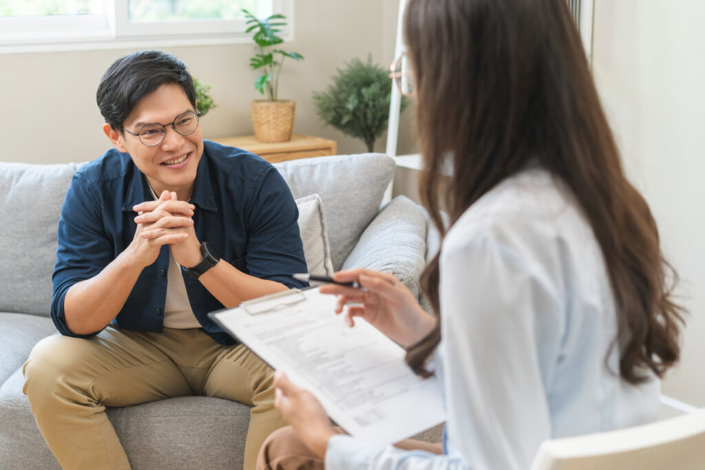 Young Asian man talking to a woman at the drug rehab at Malden MA.