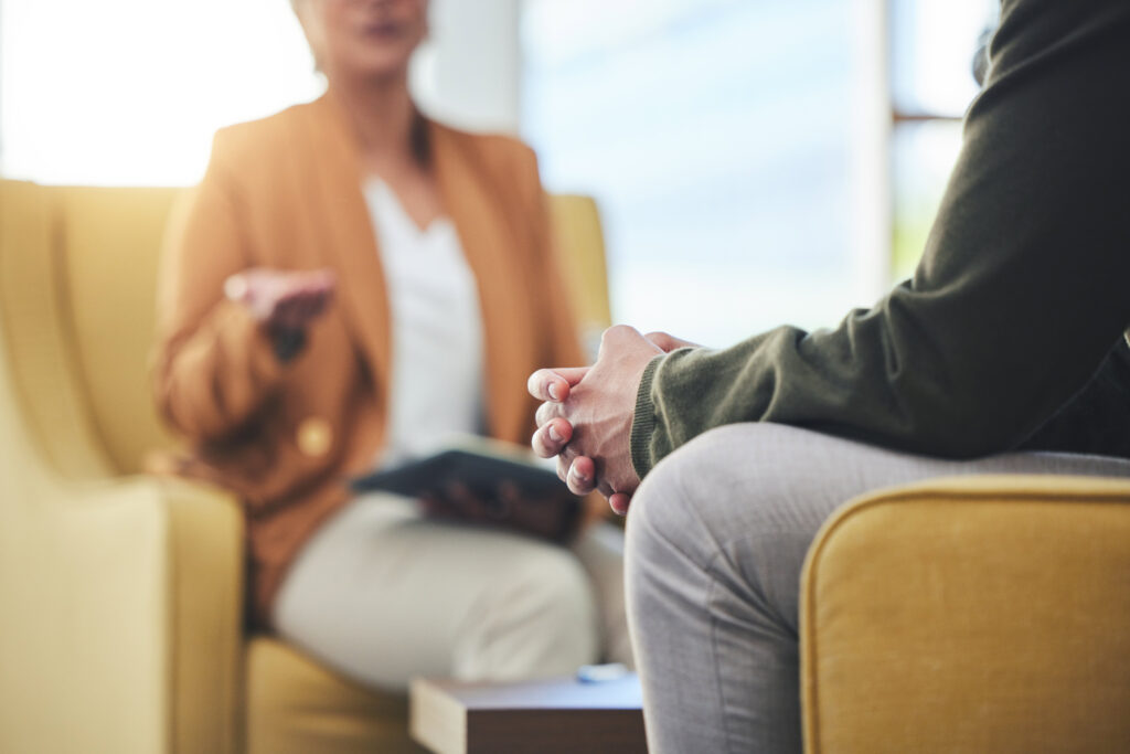 Young man talking to a woman at the drug rehab at Malden MA.