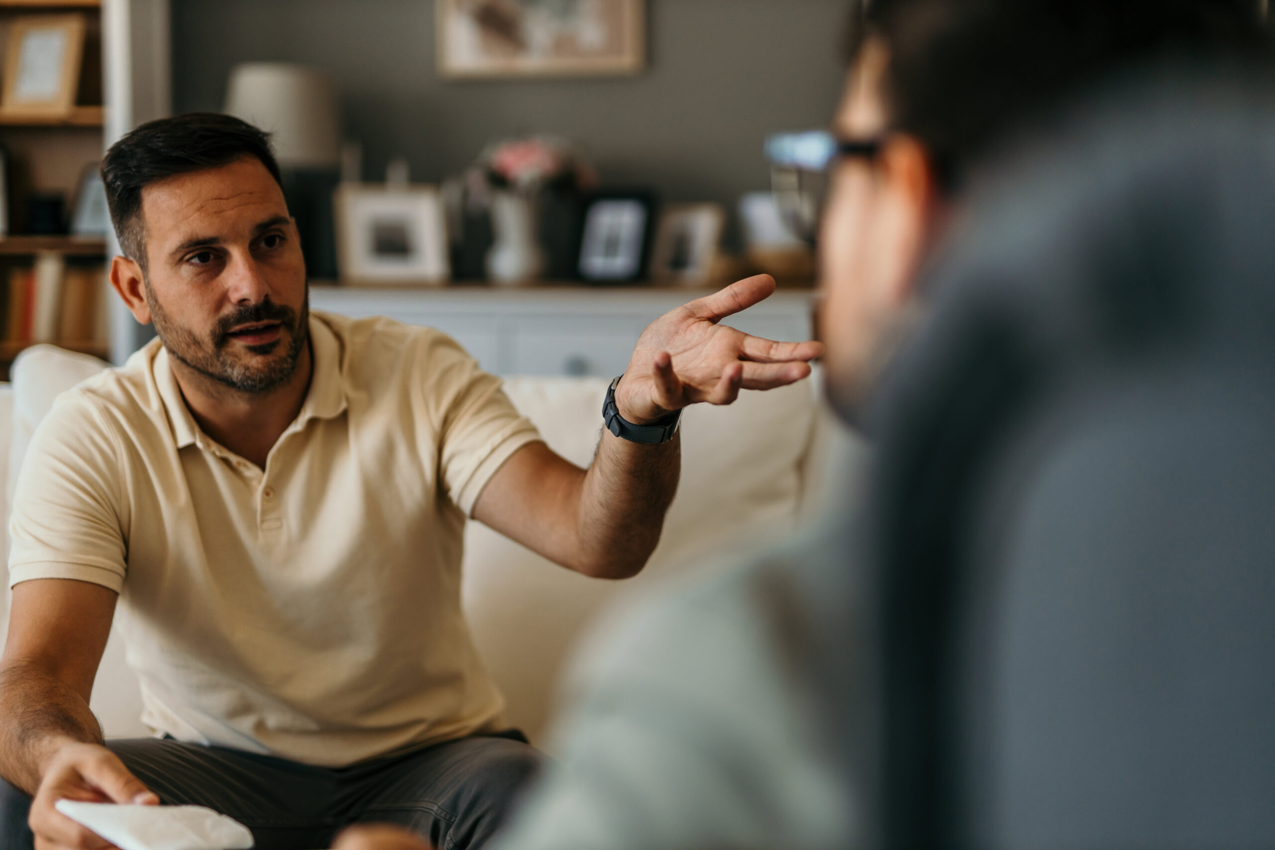 Man talking to another man at an inhalant addiction treatment facility.