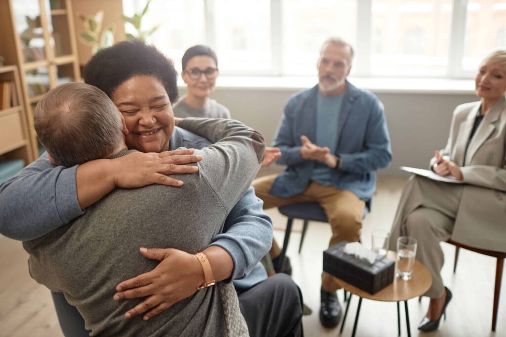 Woman and man hugging at walpole drug rehab.