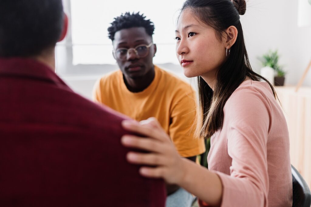 Woman showing support at a therapy group in essex county drug rehab.