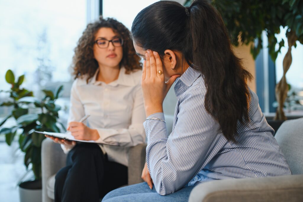 Woman talking to her therapist at a Drug and Alcohol Rehab in Barnstable County.