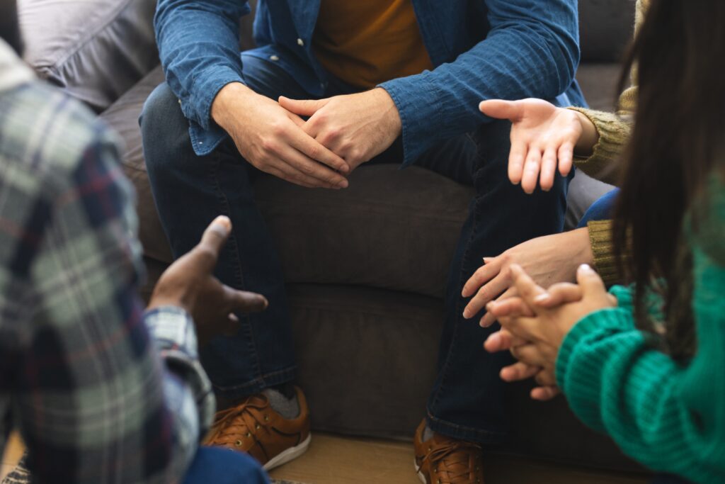 Group of people talking to therapist at drug rehab suffolk county​.