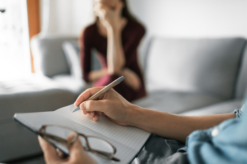 Therapist writing notes at a drug rehab worcester.