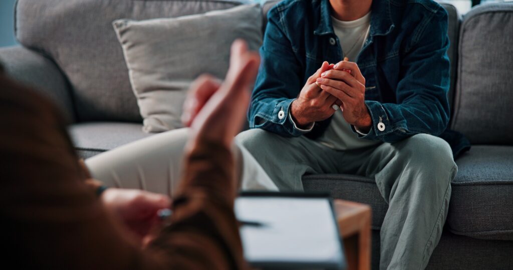 Man talking to therapist at drug rehab norfolk.
