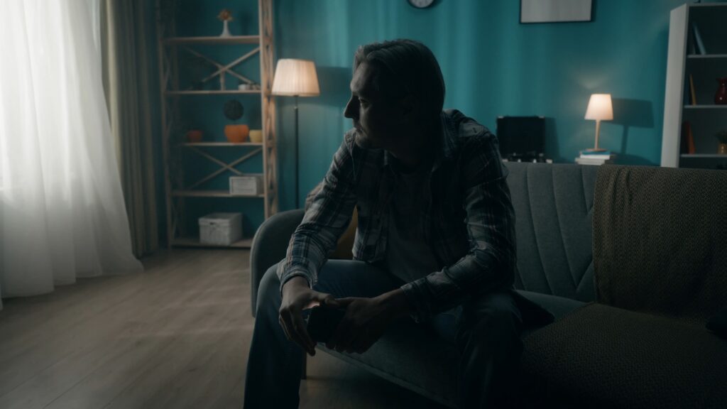A man sitting in the dark contemplating what is the most addictive substance in the world​.
