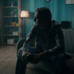 A man sitting in the dark contemplating what is the most addictive substance in the world​.