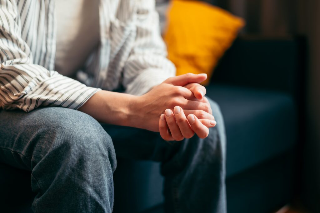 Man holding hands while sitting at drug rehab in new bedford ma.