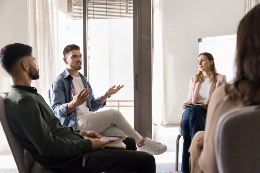 Group of men and women talking at drug rehab lynn​.